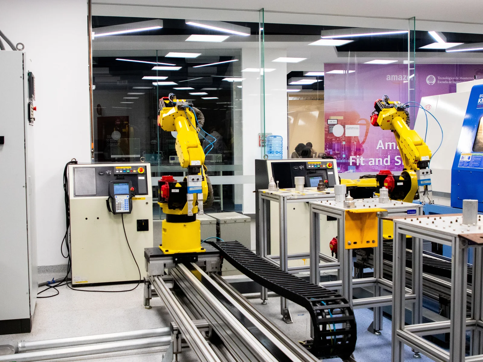 Industrial robot arms operating in a manufacturing workcell